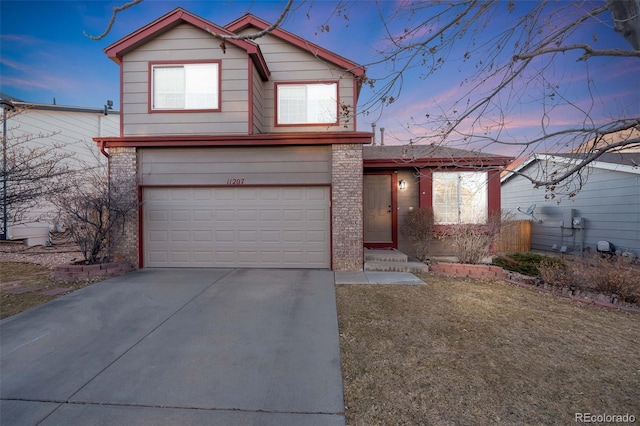 view of front facade featuring brick siding, driveway, and an attached garage