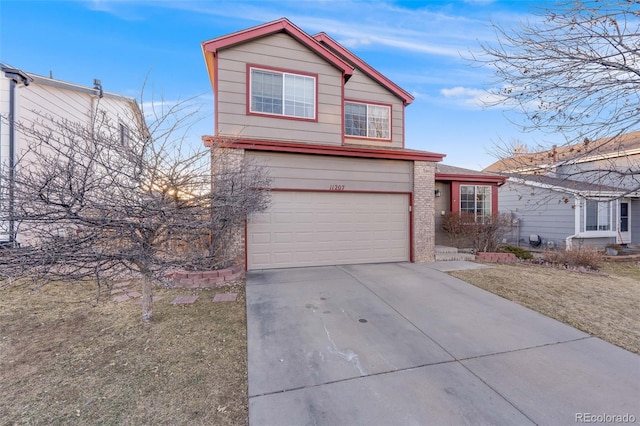 traditional-style home featuring concrete driveway, brick siding, and an attached garage