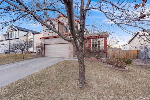 view of front of home with concrete driveway, brick siding, an attached garage, and fence