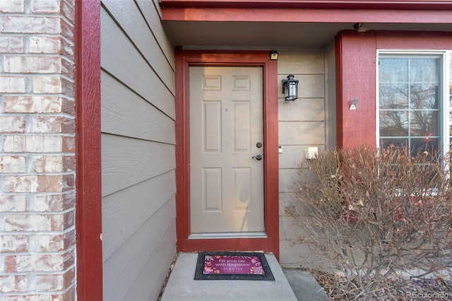 entrance to property with brick siding