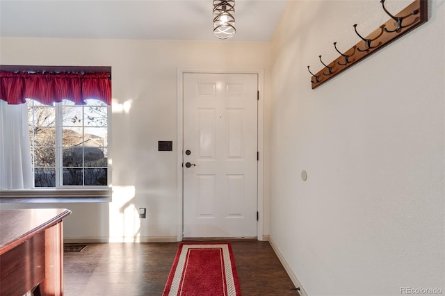 entryway featuring wood finished floors and baseboards