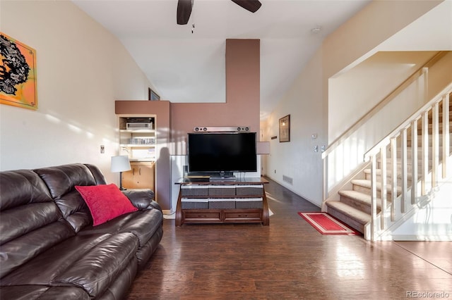 living room with dark wood-type flooring, visible vents, ceiling fan, and stairway