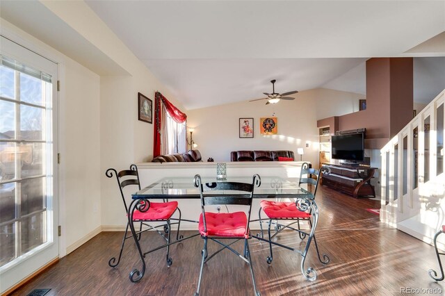 dining room with lofted ceiling, stairs, a ceiling fan, and wood finished floors