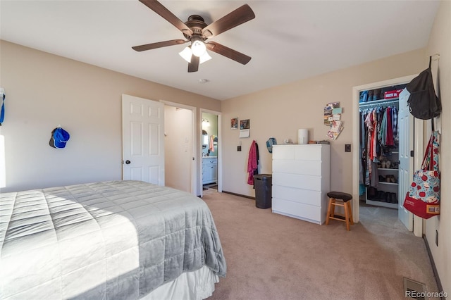 bedroom featuring a ceiling fan, a closet, and light colored carpet