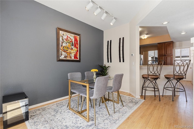 dining room featuring track lighting and light wood-type flooring