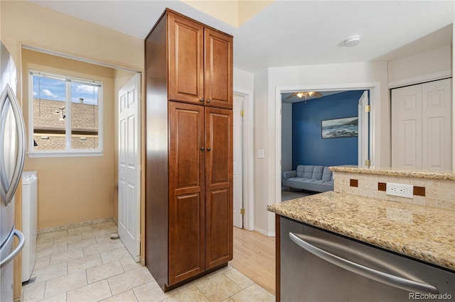 kitchen featuring light stone countertops and appliances with stainless steel finishes