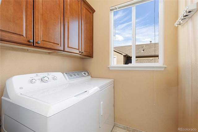 washroom featuring cabinets and washer and dryer