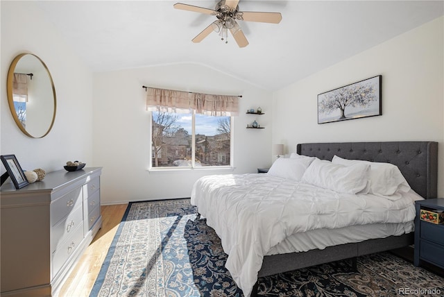 bedroom with vaulted ceiling, ceiling fan, and light hardwood / wood-style floors