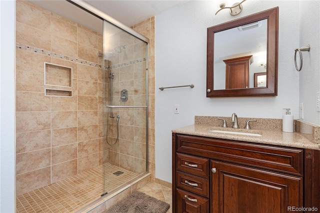 bathroom featuring vanity and a shower with shower door