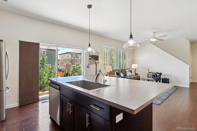 10844 Telluride St, Commerce City, CO 80022 - kitchen featuring dark wood-style flooring, appliances with stainless steel finishes, light countertops, and open floor plan