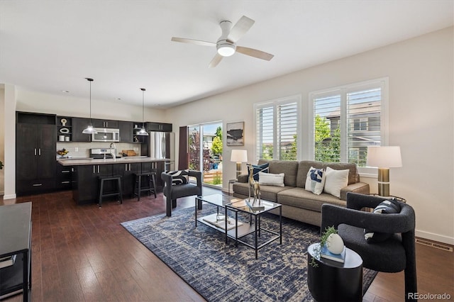 10844 Telluride St, Commerce City, CO 80022 - living room with a ceiling fan and dark wood-style flooring