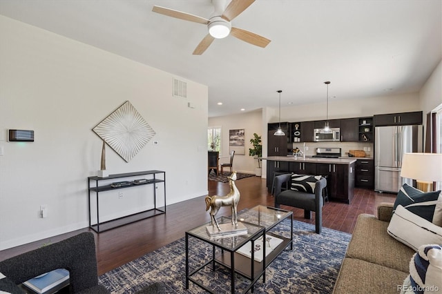 10844 Telluride St, Commerce City, CO 80022 - living area with dark wood-style floors, ceiling fan, and recessed lighting
