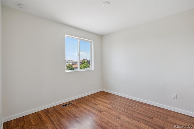 10844 Telluride St, Commerce City, CO 80022 - spare room featuring wood finished floors and a smoke detector