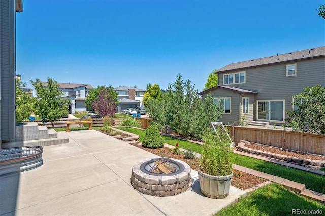 10844 Telluride St, Commerce City, CO 80022 - view of patio / terrace with an outdoor fire pit and a residential view