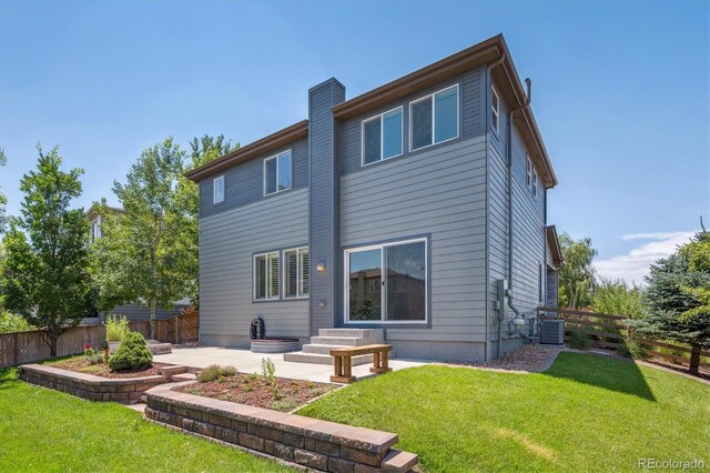 10844 Telluride St, Commerce City, CO 80022 - back of property with a patio area, a fenced backyard, and a chimney