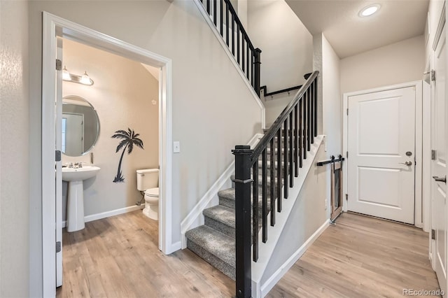 stairs featuring baseboards, recessed lighting, and wood finished floors