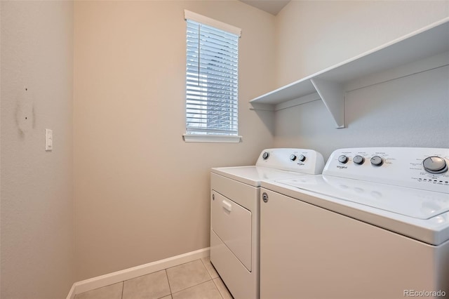 washroom featuring baseboards, laundry area, light tile patterned flooring, and independent washer and dryer