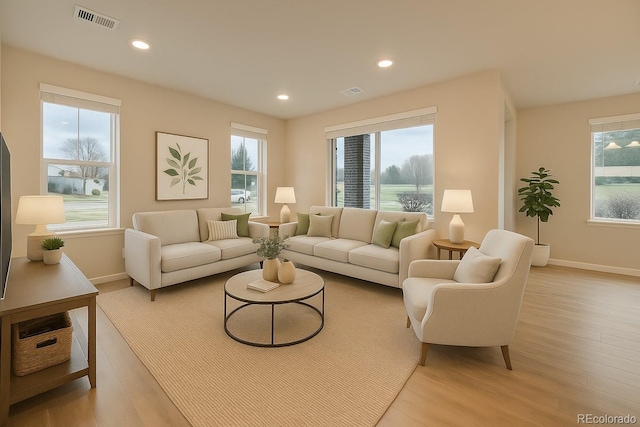 5107 S Fairplay St, Aurora, CO 80015 - living area with healthy amount of natural light, baseboards, light wood finished floors, and recessed lighting