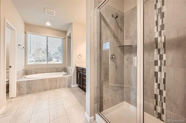 5107 S Fairplay St, Aurora, CO 80015 - bathroom featuring a shower stall, plenty of natural light, a garden tub, and toilet