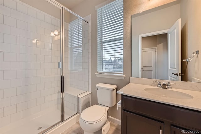 5107 S Fairplay St, Aurora, CO 80015 - full bath with toilet, vanity, a shower stall, and baseboards