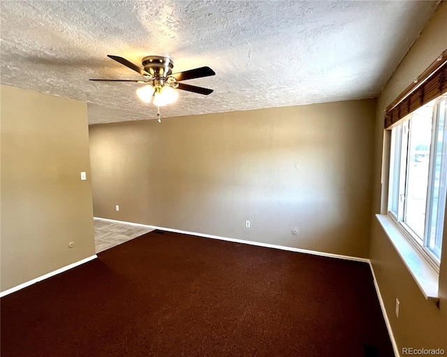 carpeted spare room with ceiling fan and a textured ceiling