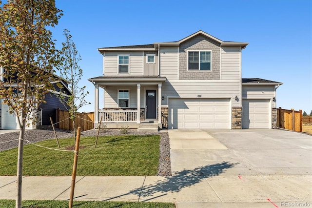 view of front of property with driveway, an attached garage, covered porch, fence, and a front yard