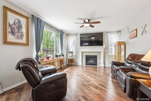 2810 Shadow Dance Dr, Castle Rock, CO 80109 - living room with ceiling fan, a fireplace, wood finished floors, and baseboards