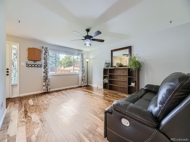 living room featuring light wood-type flooring and ceiling fan