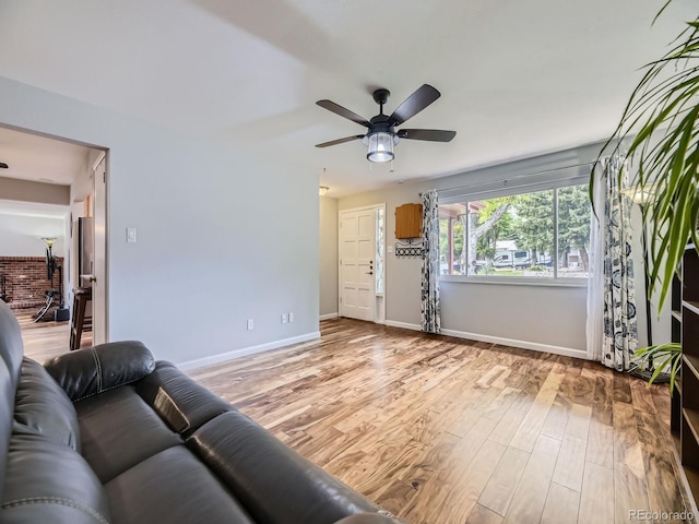 living room with ceiling fan and light wood-type flooring