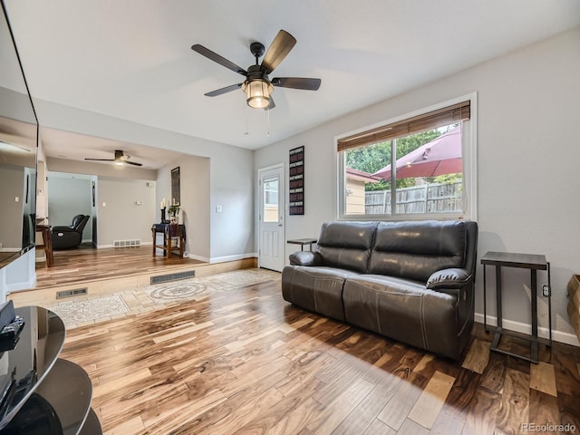 living room with ceiling fan and hardwood / wood-style floors