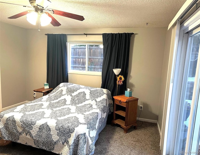 bedroom with ceiling fan, carpet, and a textured ceiling