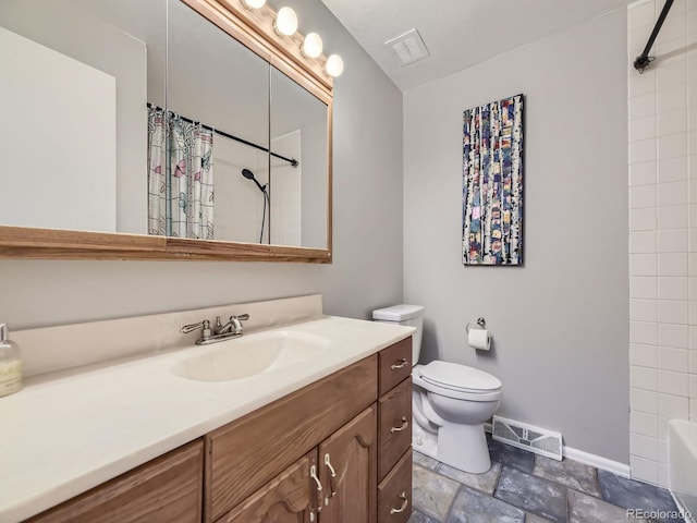 full bathroom featuring vanity, shower / bath combo, and toilet