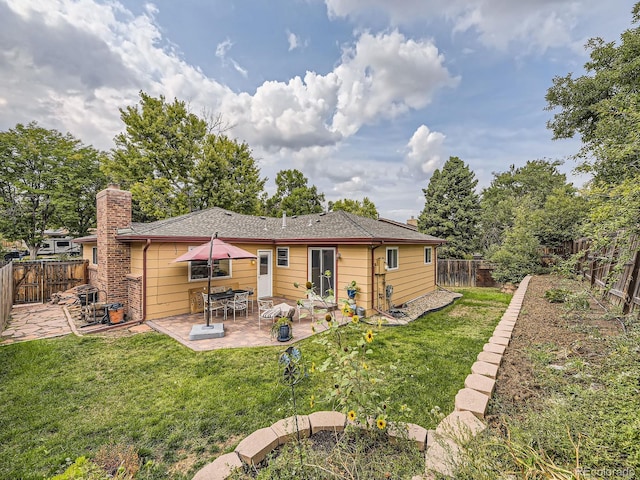 back of house featuring a yard and a patio