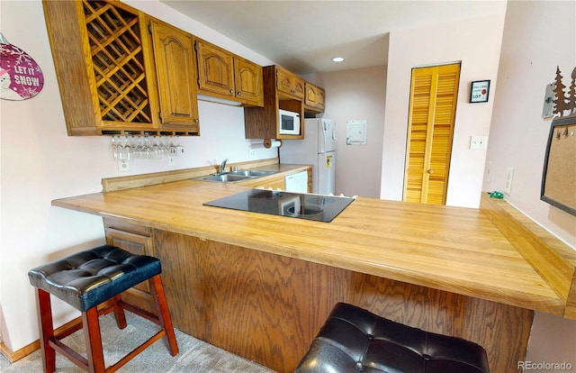 bar with recessed lighting, white appliances, indoor bar, and a sink