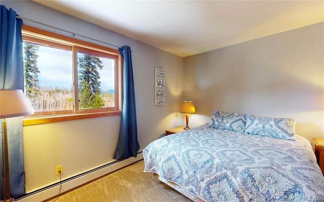 carpeted bedroom with a baseboard heating unit