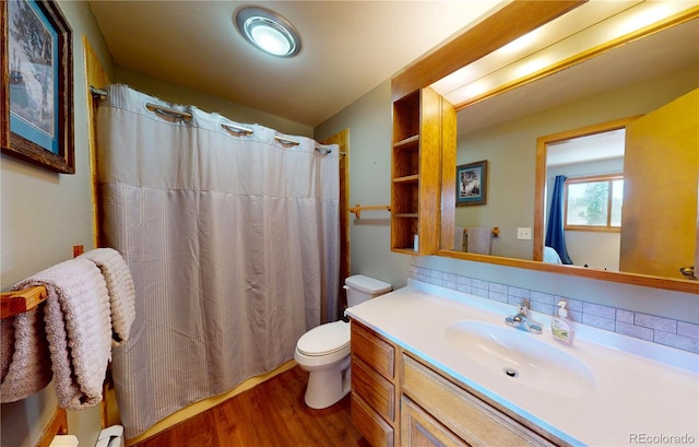bathroom featuring toilet, a shower with curtain, vanity, and wood finished floors