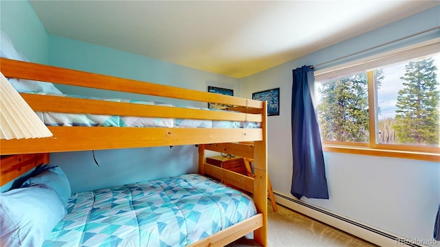 carpeted bedroom featuring baseboard heating