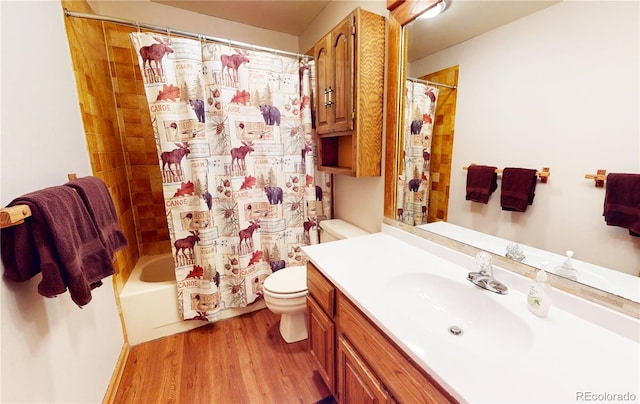 bathroom featuring vanity, toilet, shower / bath combination with curtain, and wood finished floors