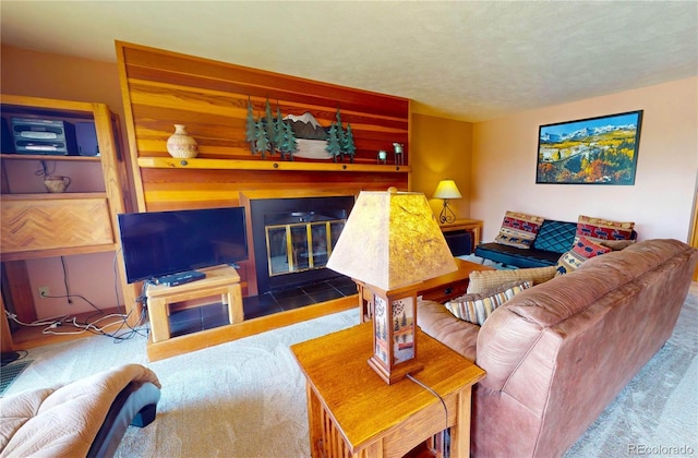 living area featuring carpet and a fireplace with flush hearth