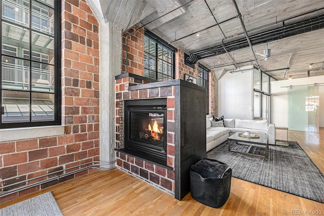 1863 Wazee St Unit 4E, Denver, CO 80202 - living area featuring wood finished floors, plenty of natural light, and a brick fireplace