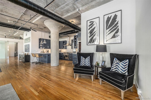 1863 Wazee St Unit 4E, Denver, CO 80202 - living area with hardwood / wood-style flooring, a high ceiling, and ornate columns