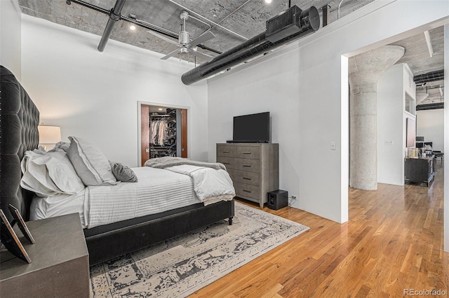 1863 Wazee St Unit 4E, Denver, CO 80202 - bedroom featuring wood finished floors, a high ceiling, a walk in closet, and a closet