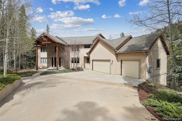30 Carroll Ct, Black Hawk, CO 80422 - view of front of home with a garage, stucco siding, concrete driveway, and roof with shingles