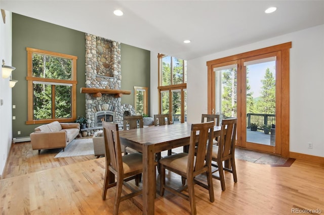 30 Carroll Ct, Black Hawk, CO 80422 - dining room with a fireplace, a baseboard radiator, light wood-type flooring, baseboards, and recessed lighting