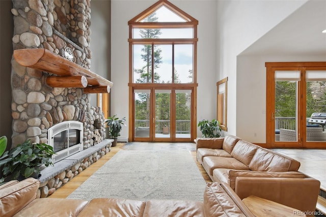 30 Carroll Ct, Black Hawk, CO 80422 - living room featuring a high ceiling, a stone fireplace, and wood finished floors