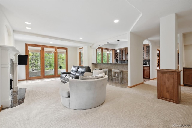 30 Carroll Ct, Black Hawk, CO 80422 - living area with light colored carpet, plenty of natural light, recessed lighting, arched walkways, and a fireplace with flush hearth