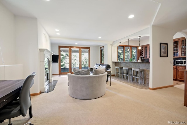 30 Carroll Ct, Black Hawk, CO 80422 - living area featuring light colored carpet, recessed lighting, baseboards, a fireplace, and arched walkways