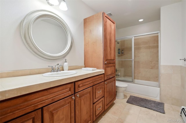 30 Carroll Ct, Black Hawk, CO 80422 - full bath with baseboard heating, vanity, tile patterned flooring, toilet, and combined bath / shower with glass door