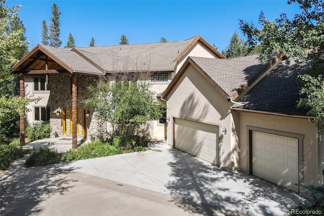 30 Carroll Ct, Black Hawk, CO 80422 - view of front of house with stucco siding, driveway, a garage, and a shingled roof