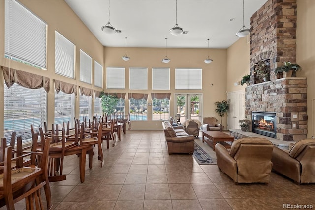 5255 Memphis St Unit 811, Denver, CO 80239 - tiled living room featuring a towering ceiling and a large fireplace